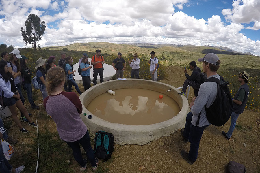Students learn about a rainwater collector in the El Campo community from a local engineering during their Spring Break research trip to Bolivia. The trip, part of the Environmental Technology in the Developing World class, included days of collecting water samples and surveying residents as well as days learning how rural communities have developed their own water systems. (Photo: Donald Smith)