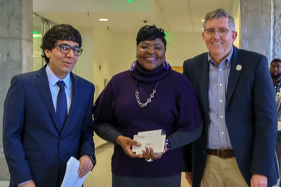 Shauna Bennett-Boyd, center, receives her award from awards committee chair Arash Yavari, left, and School Chair Donald Webster.  (Photo: Amelia Neumeister)