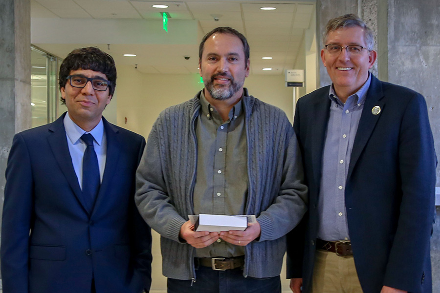 Jorge Laval, center, receives his award from awards committee chair Arash Yavari, left, and School Chair Donald Webster.  (Photo: Amelia Neumeister)