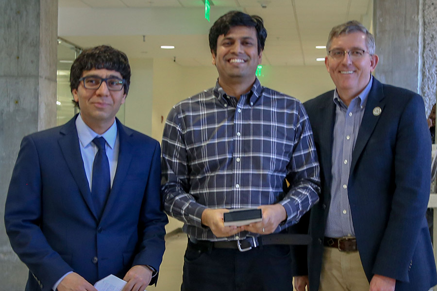 Phanish Suryanarayana, center, receives his award from awards committee chair Arash Yavari, left, and School Chair Donald Webster.  (Photo: Amelia Neumeister)