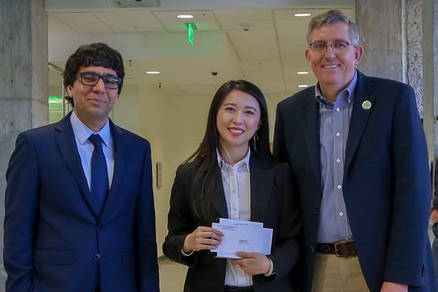 Xiaojia Shelly Zhang, center, receives her award from awards committee chair Arash Yavari, left, and School Chair Donald Webster.  (Photo: Amelia Neumeister)