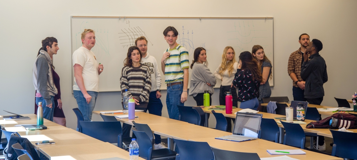 Students stand at a whiteboard during Kevn Haas's water engineering class