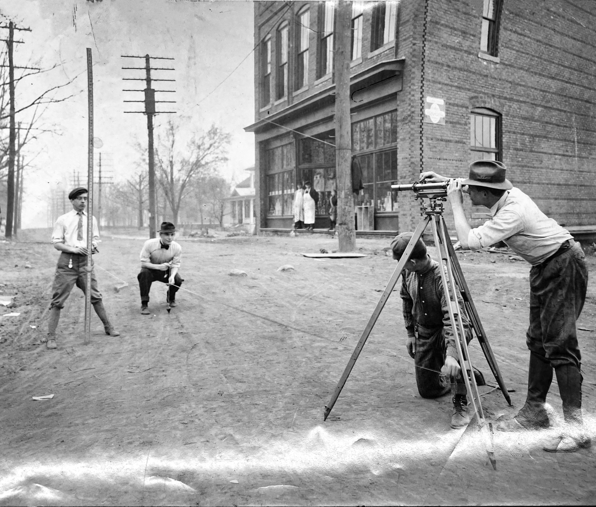 A black and white photo of surveyors in the late 19th century